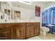 Bathroom featuring a double sink vanity and a shower/tub with ocean-themed curtain at 4609 E Ironhorse Rd, Gilbert, AZ 85297