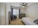 Neutral bedroom featuring a modern chair, mirror, dresser, and a ceiling fan at 4609 E Ironhorse Rd, Gilbert, AZ 85297