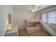 A bedroom with pink bunk beds and a slide, ceiling fan, and window with blinds at 4609 E Ironhorse Rd, Gilbert, AZ 85297