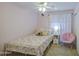 Bedroom with a floral comforter, carpet flooring, ceiling fan, and a sliding closet at 4609 E Ironhorse Rd, Gilbert, AZ 85297