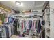 A walk-in closet with clothing racks, shelves, and a variety of clothing items and accessories at 4609 E Ironhorse Rd, Gilbert, AZ 85297