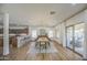 Bright dining area featuring a modern light fixture, kitchen access, and sliding door to outdoor space at 4609 E Ironhorse Rd, Gilbert, AZ 85297