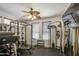 Well-lit exercise room featuring comprehensive weight training equipment, ceiling fan, and natural light from window at 4609 E Ironhorse Rd, Gilbert, AZ 85297