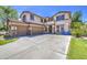 This two-story home features a spacious three car driveway and manicured lawn with a basketball hoop at 4609 E Ironhorse Rd, Gilbert, AZ 85297