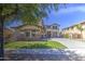 This two-story home boasts a spacious driveway, manicured lawn, and shady mature trees at 4609 E Ironhorse Rd, Gilbert, AZ 85297