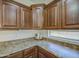 Close up of granite counters and custom wood cabinets in kitchen with stainless steel sink and fixtures at 4609 E Ironhorse Rd, Gilbert, AZ 85297