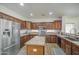 This open kitchen offers stainless steel appliances, custom cabinetry, granite countertops, and island with sink at 4609 E Ironhorse Rd, Gilbert, AZ 85297