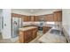Bright kitchen boasts custom wood cabinetry, stainless steel appliances and island with sink and additional storage at 4609 E Ironhorse Rd, Gilbert, AZ 85297