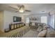 Comfortable living room with a large sectional sofa, stylish rug, and modern entertainment center at 4609 E Ironhorse Rd, Gilbert, AZ 85297