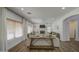 Spacious living room featuring hardwood floors, a ceiling fan, and a large window for natural light at 4609 E Ironhorse Rd, Gilbert, AZ 85297