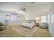 Bright main bedroom with a ceiling fan, seating, and a large rug at 4609 E Ironhorse Rd, Gilbert, AZ 85297