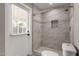Modern bathroom featuring large tiled shower, rain shower head, mosaic accents, and access to the backyard at 4939 E Paradise Dr, Scottsdale, AZ 85254