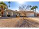 Charming single-story home with desert landscaping, palm trees, and a two-car garage at 4939 E Paradise Dr, Scottsdale, AZ 85254