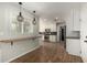 Bright kitchen featuring white cabinets, stainless steel appliances, breakfast bar, and stylish pendant lighting at 4939 E Paradise Dr, Scottsdale, AZ 85254