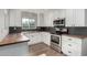 Bright kitchen with white cabinets, stainless steel appliances, butcher block counters, and modern backsplash at 4939 E Paradise Dr, Scottsdale, AZ 85254