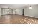 Bright, open living area with a large window, ceiling fan, and hardwood floors at 4939 E Paradise Dr, Scottsdale, AZ 85254
