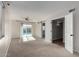 Spacious living room featuring a ceiling fan, sliding glass doors to pool, and barn door to bonus room at 4939 E Paradise Dr, Scottsdale, AZ 85254