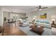 Open-concept living room with hardwood floors, neutral paint, modern furnishings, and seamless flow to dining area at 4939 E Paradise Dr, Scottsdale, AZ 85254