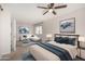 Spacious main bedroom with seating area, stylish decor, ceiling fan, and abundant natural light at 4939 E Paradise Dr, Scottsdale, AZ 85254