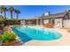 Refreshing pool area with lush landscaping, covered patio, outdoor seating, and serene backyard setting at 4939 E Paradise Dr, Scottsdale, AZ 85254