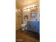 Well-lit bathroom with a glass shower, patterned mirror and a rustic wooden floor at 5141 E Rancho Tierra Dr, Cave Creek, AZ 85331