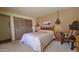 Comfortable bedroom with wooden accents, stylish hanging lights, and neutral carpet at 5141 E Rancho Tierra Dr, Cave Creek, AZ 85331