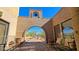 Charming brick courtyard with rustic seating, landscaping, and an outdoor archway at 5141 E Rancho Tierra Dr, Cave Creek, AZ 85331