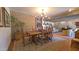 Spacious dining room with wood table, brick accent wall, and chandelier at 5141 E Rancho Tierra Dr, Cave Creek, AZ 85331