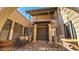 Elegant entrance with double doors, decorative columns, and brick-paved courtyard at 5141 E Rancho Tierra Dr, Cave Creek, AZ 85331