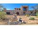 Custom home with brick exterior, fountain, landscaped yard, and desert surroundings at 5141 E Rancho Tierra Dr, Cave Creek, AZ 85331