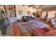 Spacious living room with brick accents, a beamed ceiling, and inviting seating areas at 5141 E Rancho Tierra Dr, Cave Creek, AZ 85331