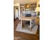 A home office with a built-in bookcase, hardwood floors, and a round table desk at 5141 E Rancho Tierra Dr, Cave Creek, AZ 85331