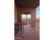 Charming brick patio with desert views and wrought iron furniture at 5141 E Rancho Tierra Dr, Cave Creek, AZ 85331