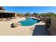 Desert backyard with a large pool, scenic landscaping, and beautiful pavers at 5141 E Rancho Tierra Dr, Cave Creek, AZ 85331