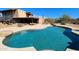 Beautiful backyard pool with lounge area, landscaping, and blue skies at 5141 E Rancho Tierra Dr, Cave Creek, AZ 85331