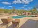 Beautiful backyard swimming pool with lounging chairs, and desert landscape views at 5141 E Rancho Tierra Dr, Cave Creek, AZ 85331