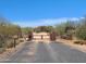 Property gate with metal gate and mature desert landscaping at 5141 E Rancho Tierra Dr, Cave Creek, AZ 85331