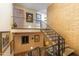 Grand staircase featuring a brick wall, iron railings, and an artistic flair at 5141 E Rancho Tierra Dr, Cave Creek, AZ 85331