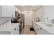 Bright kitchen features white cabinets, stainless steel appliances, and modern countertops at 623 W Guadalupe Rd # 288, Mesa, AZ 85210