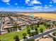 Community aerial view featuring homes near well-tended green spaces, farms, and open plains at 683 W Honey Locust Ave, Queen Creek, AZ 85140
