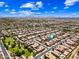 Neighborhood aerial shot showcasing community with parks, nearby mountains, and other residences at 683 W Honey Locust Ave, Queen Creek, AZ 85140