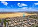 Aerial of neighborhood with homes with pools, farms, and the distant mountains at 683 W Honey Locust Ave, Queen Creek, AZ 85140