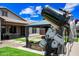Well maintained backyard with artificial grass, patio furniture, and a telescope at 683 W Honey Locust Ave, Queen Creek, AZ 85140