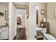 View of a quaint powder room featuring sink, toilet, decor, and dark wood floors throughout the hall at 683 W Honey Locust Ave, Queen Creek, AZ 85140