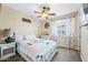 Inviting bedroom with a queen-sized bed and light-filtering floral curtains at 683 W Honey Locust Ave, Queen Creek, AZ 85140