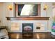 Elegant fireplace with a wooden mantle and large television mounted above, adding a cozy and modern touch at 683 W Honey Locust Ave, Queen Creek, AZ 85140