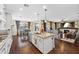 Open-concept kitchen with a large island, granite countertops, stainless steel appliances and access to the living area at 683 W Honey Locust Ave, Queen Creek, AZ 85140