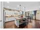 Bright kitchen featuring white cabinetry, granite countertops, a spacious island and a breakfast nook with dining table at 683 W Honey Locust Ave, Queen Creek, AZ 85140