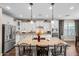 Bright kitchen featuring a large center island, white cabinetry, stainless steel appliances, and granite countertops at 683 W Honey Locust Ave, Queen Creek, AZ 85140