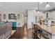 Open-concept living space boasts a granite kitchen island and bar seating at 683 W Honey Locust Ave, Queen Creek, AZ 85140